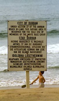 Part of the material landscape of apartheid: a sign on a Natal beach forbidding bathing by non-whites. Used under a Creative Commons license from Wikipedia user 