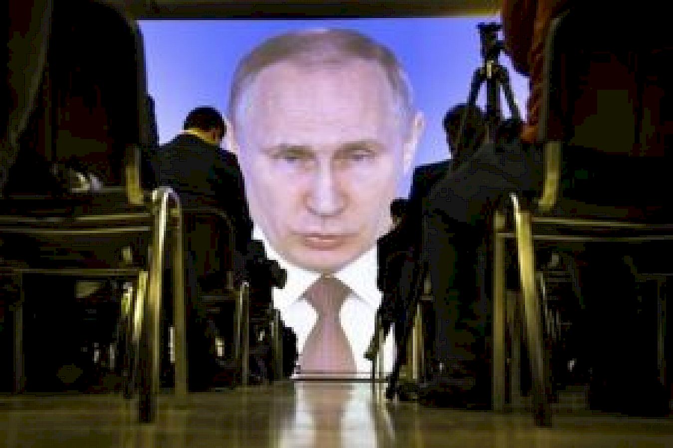 Journalists watch as Russian President Vladimir Putin gives his annual state of the nation address in Manezh in Moscow, Russia. Source: AP Photo/Alexander Zemlianichenko.