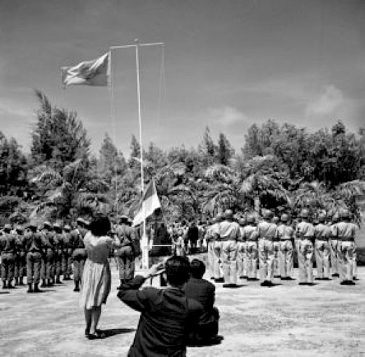 The raising of an Indonesian flag alongside a United Nations flag in West Papua (1962).